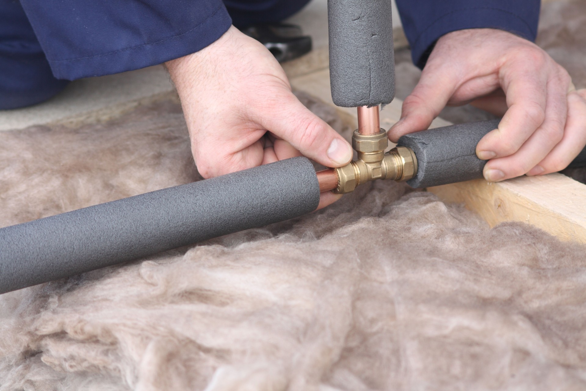 Plumber connecting copper water pipes.